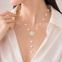 Key simulated pearl necklace with white enamel flower pendant on gold-plated chain