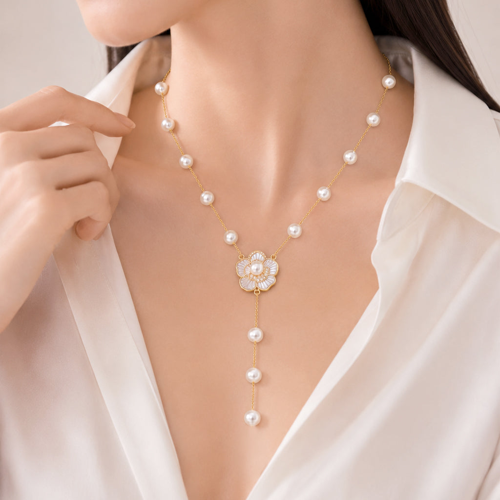Key simulated pearl necklace with white enamel flower pendant on gold-plated chain
