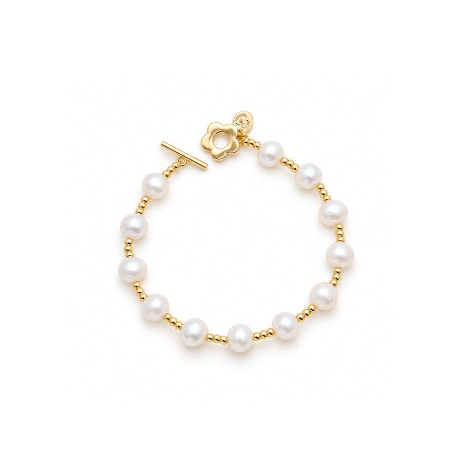 Freshwater Pearl Bracelet with lustrous white round pearls, gold spacer beads and a decorative gold toggle clasp.