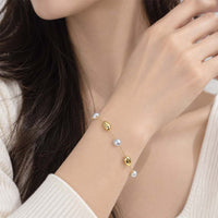 Freshwater Pearl Bracelet with delicate white pearls and polished gold-tone links, featuring a fine adjustable chain design.