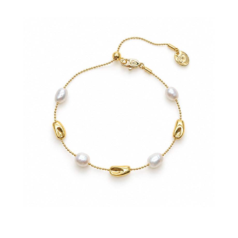 Freshwater Pearl Bracelet with a fine gold-tone chain, white oval pearls, and polished sculpted bead accents.