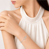 Heart & Ring Cubic Zirconia bracelet with interlocking heart and ring charms on rhodium plated chain