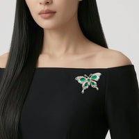 Gold plated butterfly cubic zirconia brooch with green stones and C clasp closure