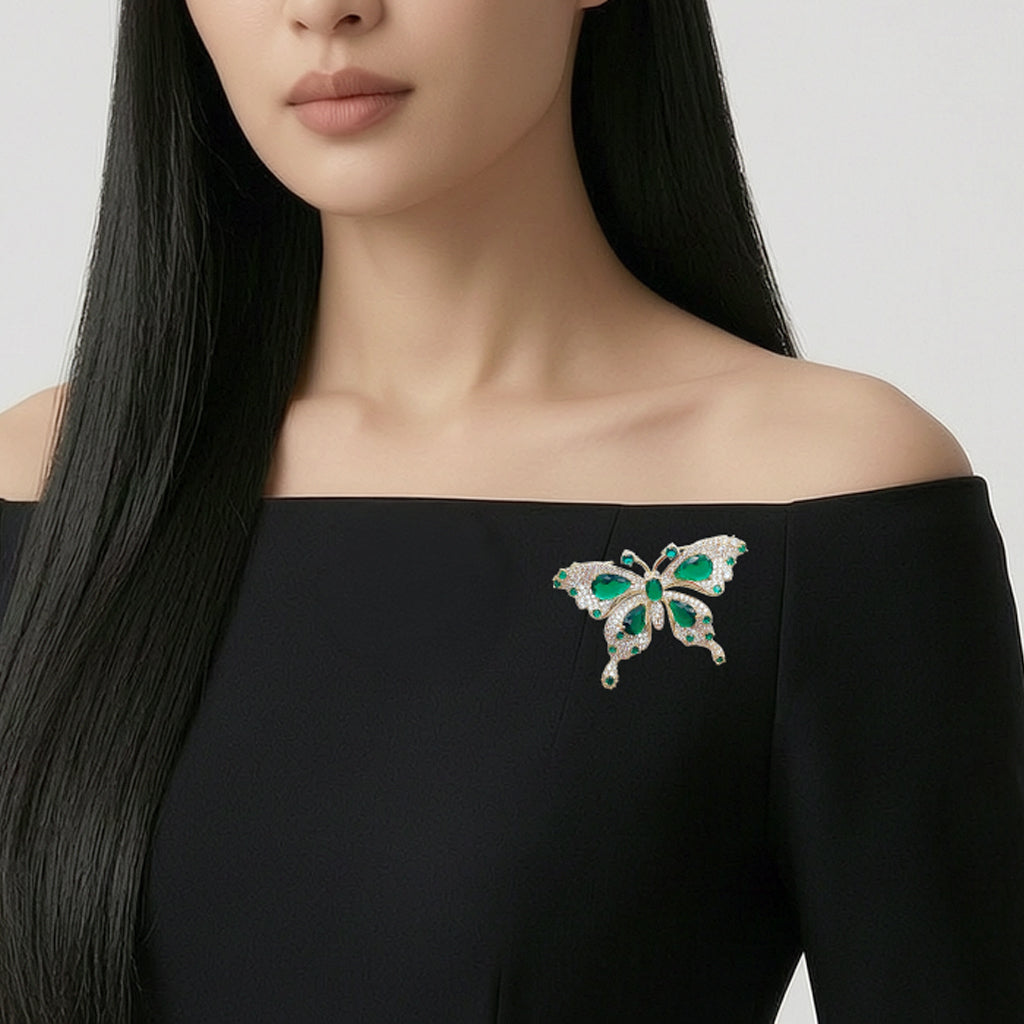 Gold plated butterfly cubic zirconia brooch with green stones and C clasp closure