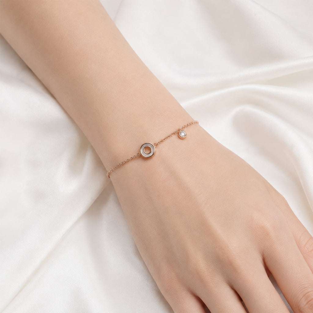 Round mother of pearl bracelet with rose gold plating and cubic zirconia charm