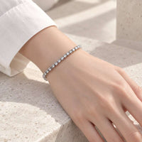 Cubic Zirconia Tennis Bracelet with a slim silver-tone metal band set with a continuous row of round clear stones.