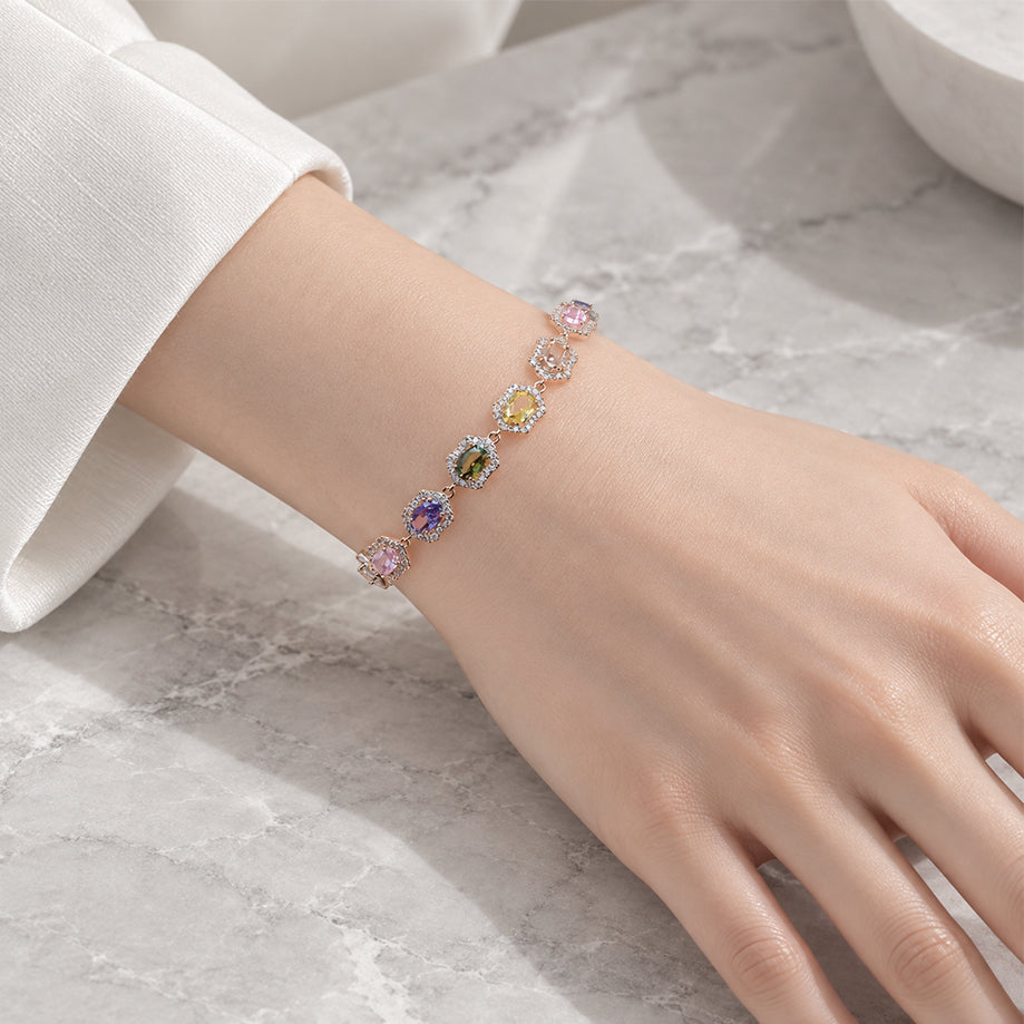 Cubic Zirconia Tennis Bracelet with colourful pastel stones framed in hexagonal rosegold plated settings on wrist.