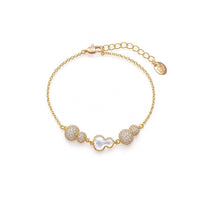 Gourd-Hulu cubic zirconia bracelet with a gold-tone chain, sparkling clustered stones and a white mother-of-pearl gourd charm.