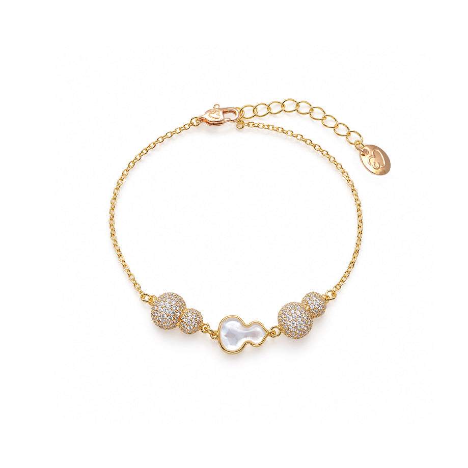 Gourd-Hulu cubic zirconia bracelet with a gold-tone chain, sparkling clustered stones and a white mother-of-pearl gourd charm.