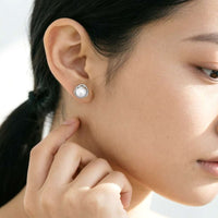 Freshwater pearl earrings with 6mm button pearls and rhodium-plated silver rims, 9mm diameter studs
