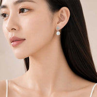 Starburst cubic zirconia clip-on earrings with rhodium plating and faceted ball drop
