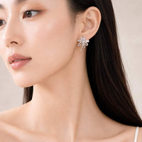 Cubic zirconia flower bouquet clip-on earrings with ribbon detail and rhodium plating