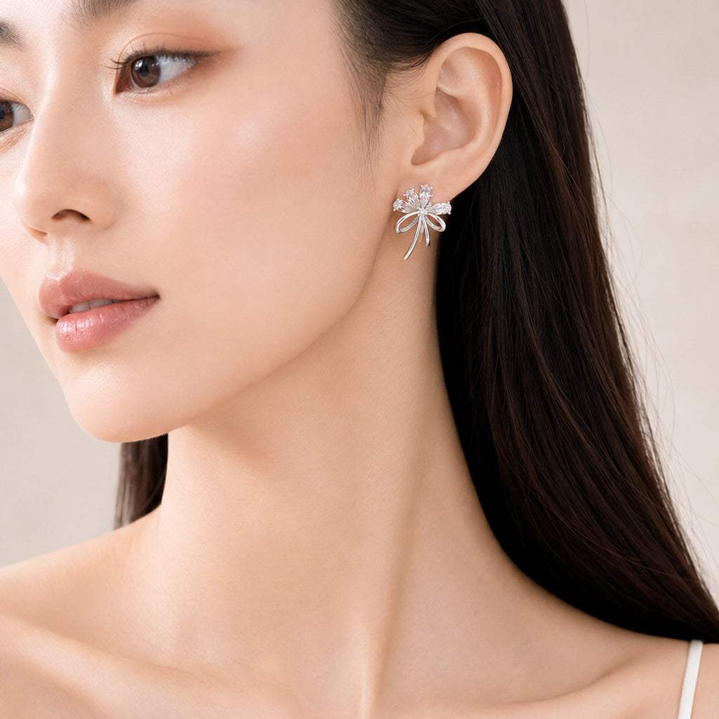 Cubic zirconia flower bouquet clip-on earrings with ribbon detail and rhodium plating