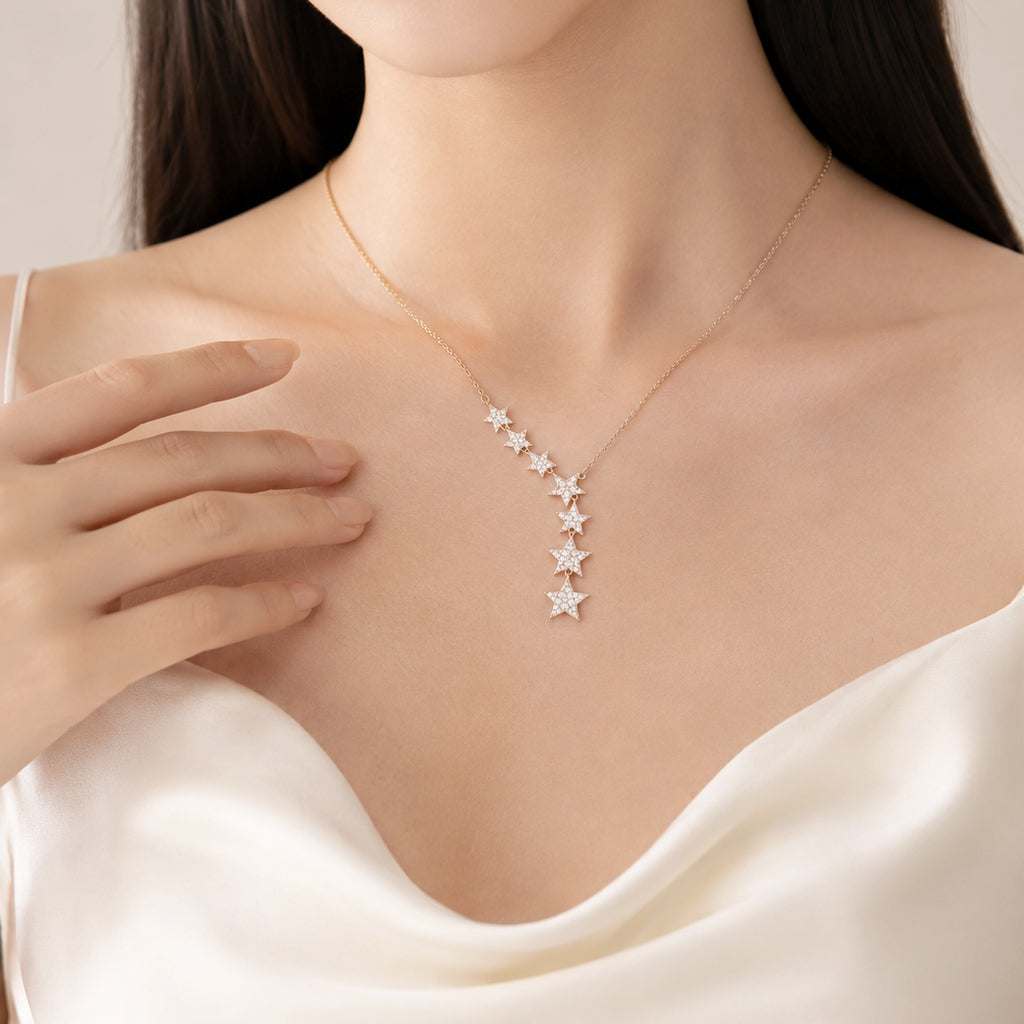 Rosegold necklace with 7 cubic zirconia star pendants in V-shaped drop design