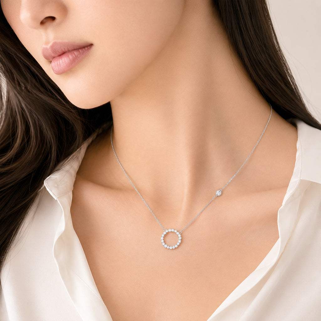 Round cubic zirconia necklace with 3mm side stone and rhodium finish pendant