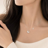 Planet cubic zirconia necklace with star accent and rhodium plated finish on adjustable chain