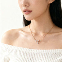 Ribbon cubic zirconia necklace with rosegold ribbon pendant and dangling solitaire stone