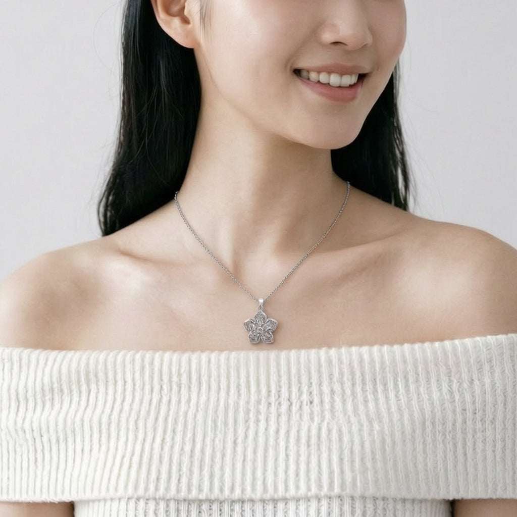 Spinning flower necklace with cubic zirconia pendant on rhodium plated chain