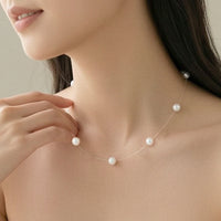 17-inch floating freshwater pearl necklace with nylon string and rhodium clasp