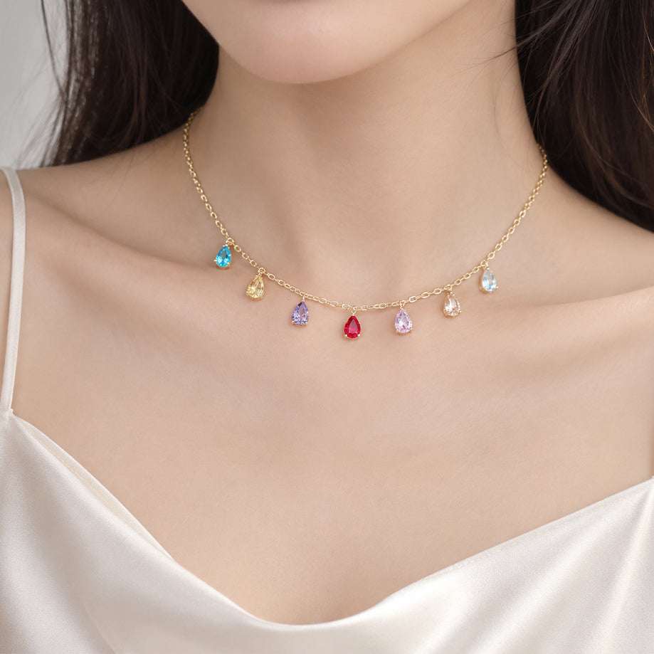 Cubic Zirconia Necklace with a fine gold-tone chain and multicoloured teardrop stones spaced along its length.