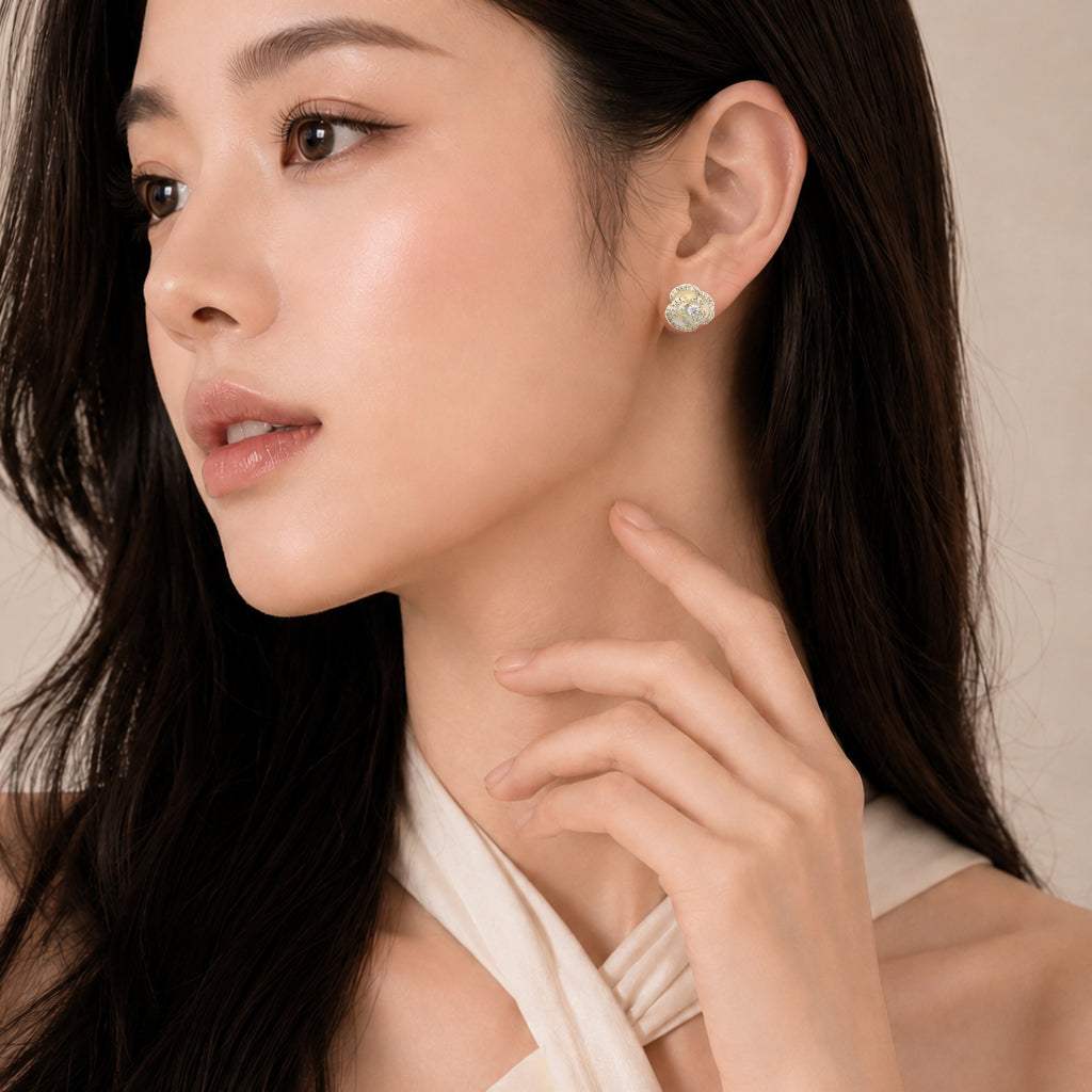 White enamel flower cubic zirconia stud earrings with gold plated finish and hypoallergenic posts