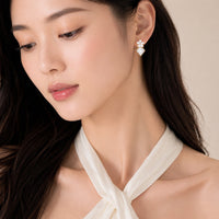 Diamond-shaped mother of pearl gold earrings with flower cubic zirconia studs