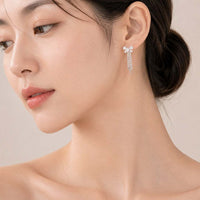 Ribbon cubic zirconia earrings with rhodium plating and tassel drop design