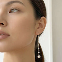 Elegant freshwater pearl earrings with gold plated hooks and long dangling pearls