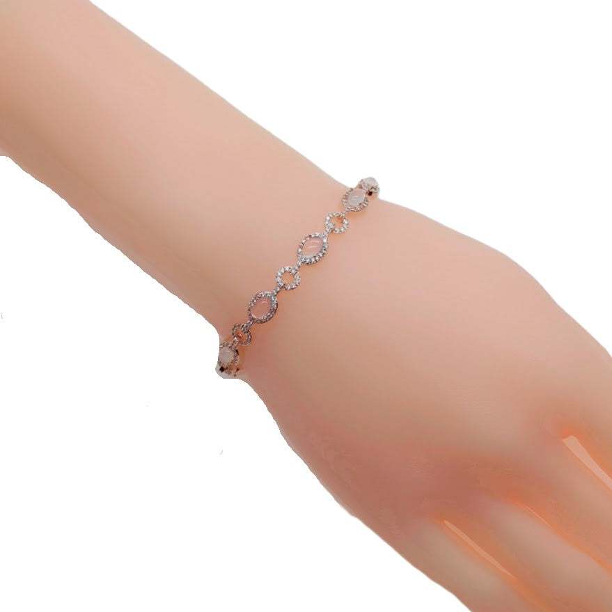Rosegold plated cubic zirconia tennis bracelet with oval moonstones and small stone border, 16 cm length.