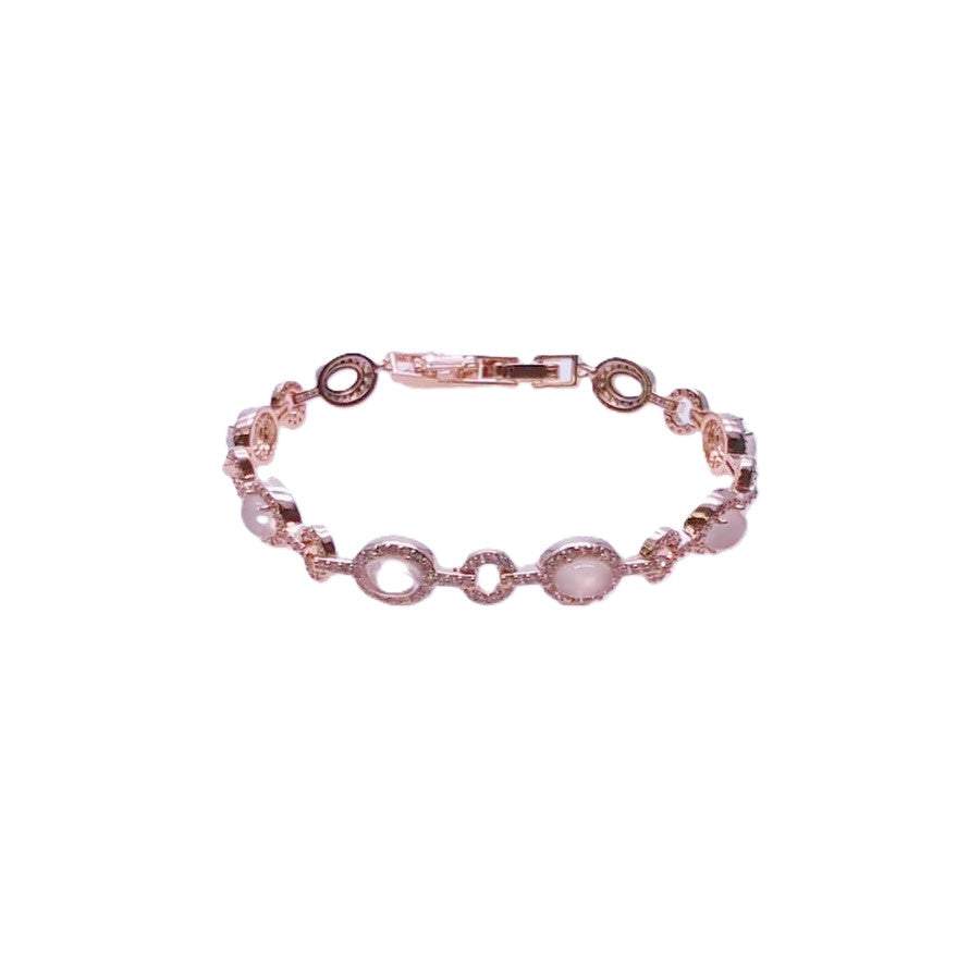 Cubic zirconia tennis bracelet with rosegold plated finish and oval moonstone accents