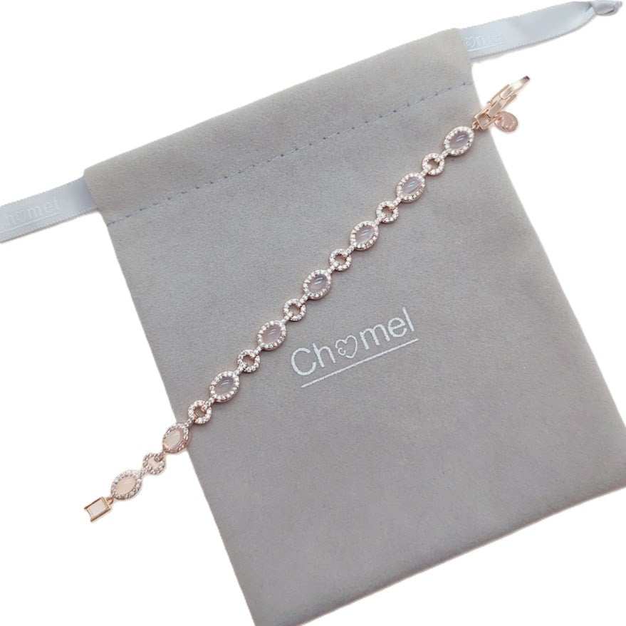Rosegold plated cubic zirconia tennis bracelet with oval moonstones and small stone border, 16 cm length