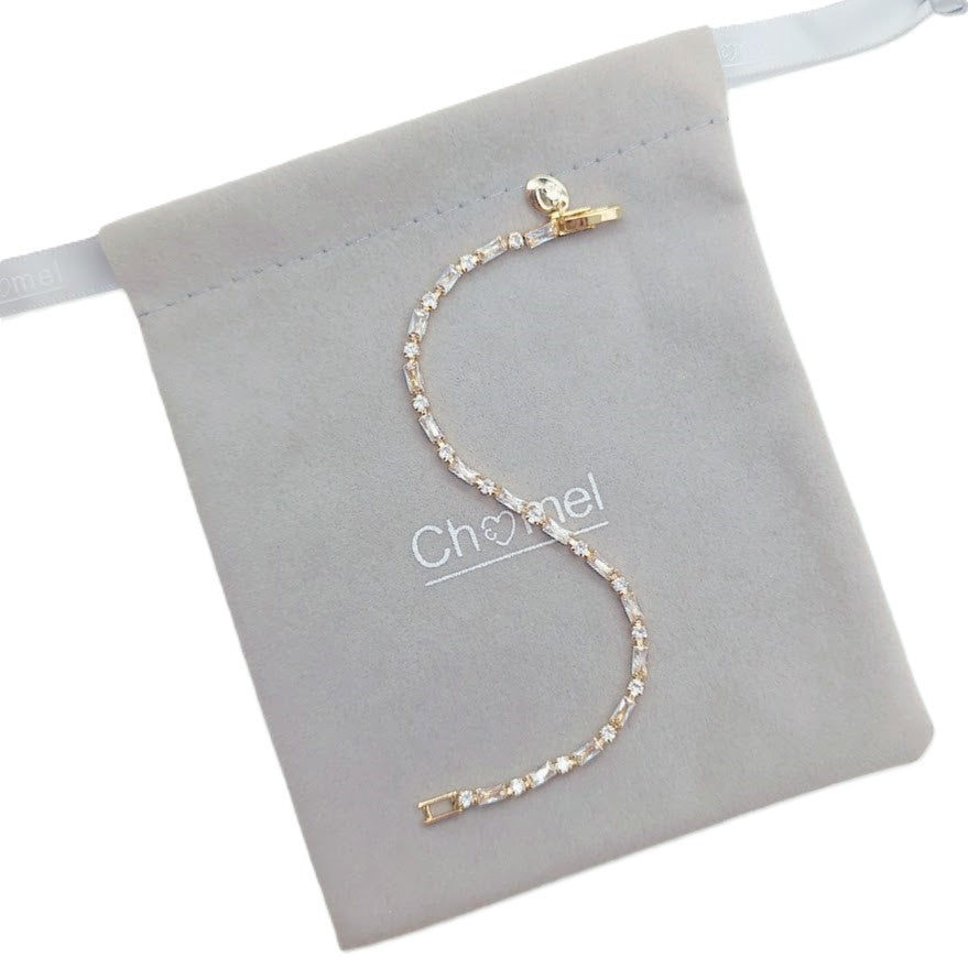 Cubic Zirconia Tennis Bracelet in gold-plated metal with a single row of sparkling baguette-cut stones and clasp.