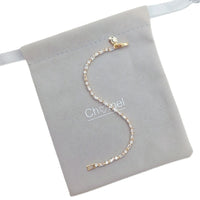 Cubic Zirconia Tennis Bracelet in gold-plated metal with a single row of sparkling baguette-cut stones and clasp.