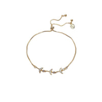 Cubic Zirconia Tennis Bracelet in gold-plated metal, featuring three mermaid-tail charms with sparkling stones and sliding adjuster