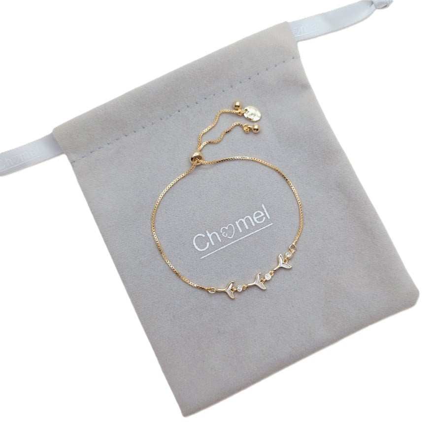 Cubic Zirconia Tennis Bracelet in gold-plated metal with delicate chain and sparkling floral accents, adjustable slider clasp