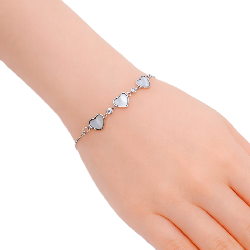 Cubic Zirconia Tennis Bracelet with three silver-toned mother-of-pearl heart charms and sparkling stones
