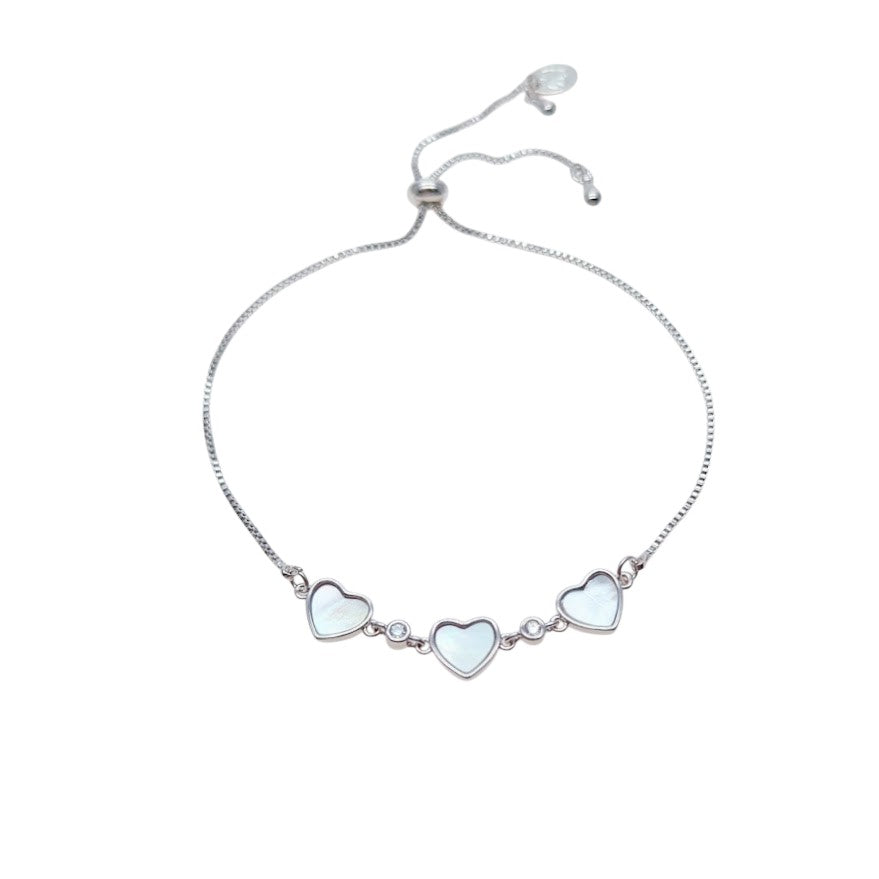 Cubic Zirconia Tennis Bracelet with three mother-of-pearl heart charms and sparkling stones, silver-tone sliding design