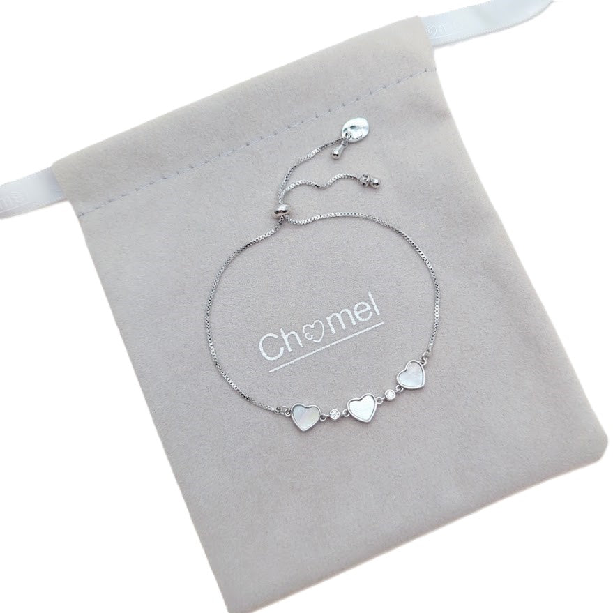 Cubic Zirconia Tennis Bracelet in silver-toned metal with three mother-of-pearl hearts and sparkling stones, adjustable slider chain