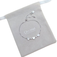 Cubic Zirconia Tennis Bracelet in silver-toned metal with three mother-of-pearl hearts and sparkling stones, adjustable slider chain