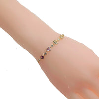 Colorful cubic zirconia tennis bracelet with diamond, heart, oval, and circle shapes, gold plated adjustable sliding design.