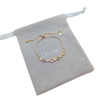 Colorful cubic zirconia tennis bracelet with diamond, heart, oval, and circle shapes, gold plated and adjustable sliding length.
