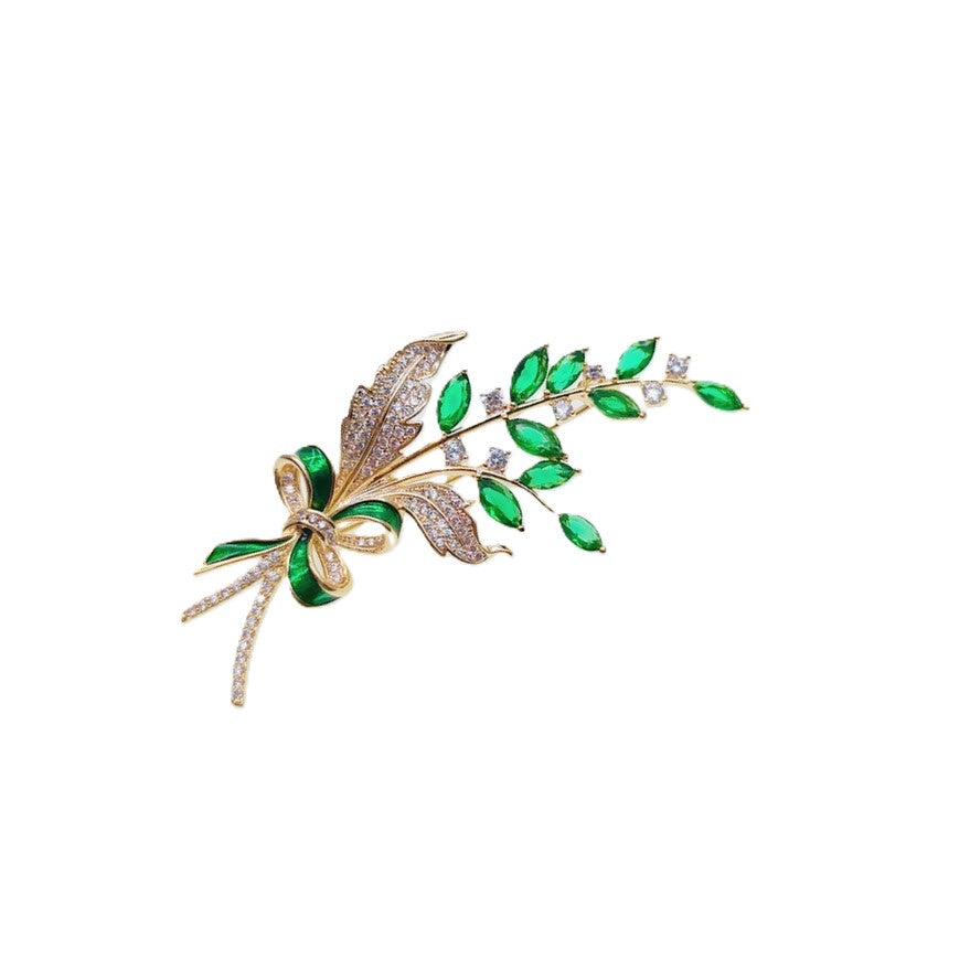 Gold plated leaf cubic zirconia brooch with green stones and C clasp closure