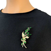 Gold plated leaf cubic zirconia brooch with green stones, 6.4cm x 3cm, nature-inspired design