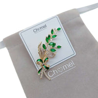 Gold plated leaf cubic zirconia brooch with green stones and C clasp closure