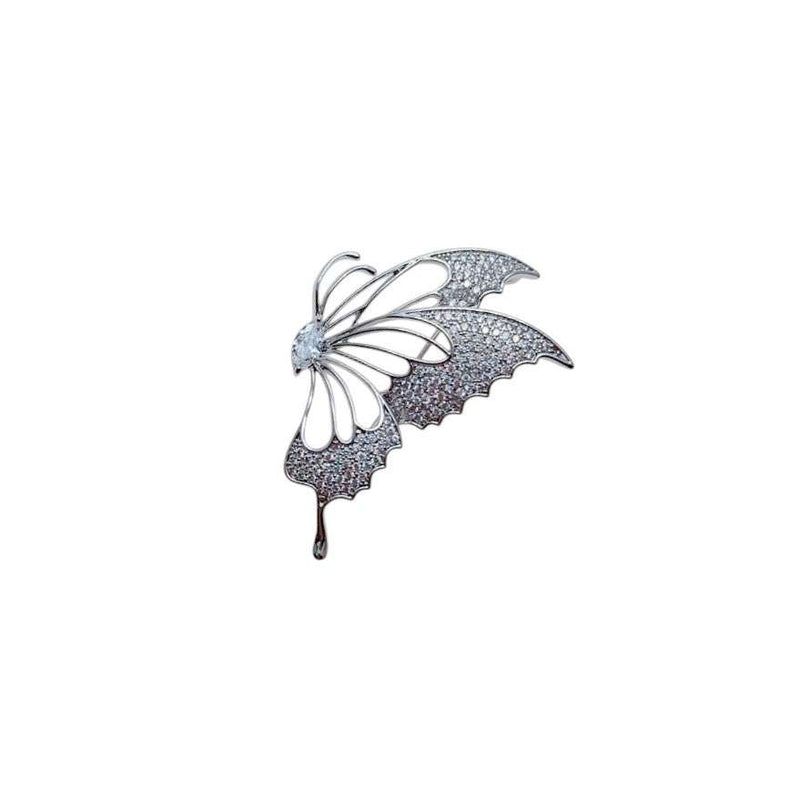 Silver-tone cubic zirconia brooch shaped as a half butterfly, with sparkling pavé wings and openwork details.