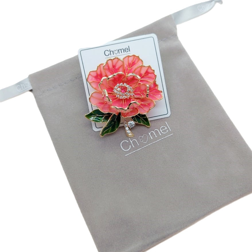 Cubic Zirconia Brooch with layered pink and coral enamel flower petals, green leaves, gold-tone edges and sparkling central stones.