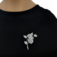 Cubic Zirconia Brooch with sparkling silver-tone rose flowers and leaves, arranged as an elegant floral spray.