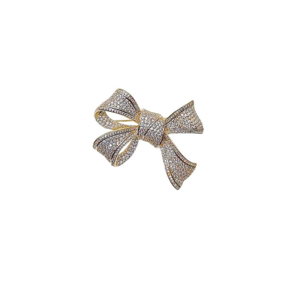 Gold plated ribbon cubic zirconia brooch with fluid design and C clasp closure