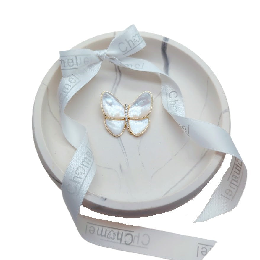 Butterfly Mother of Pearl Brooch with pearlescent white wings, gold-tone outline and sparkling crystal body, in a gift box.