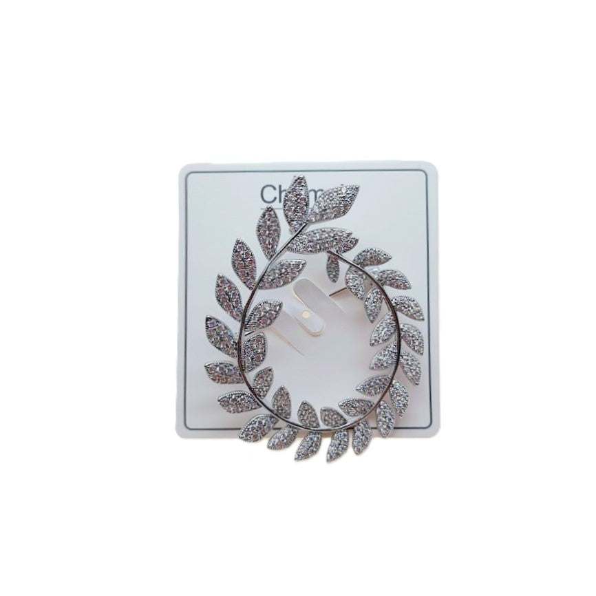 Cubic Zirconia Brooch with a silver-tone leafy wreath design, set with clear sparkling stones and an open oval centre.